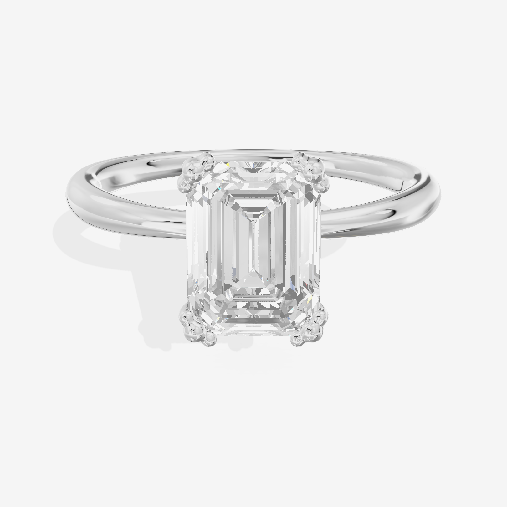 Classic Tender Emerald Solitaire Engagement Ring in Platinum