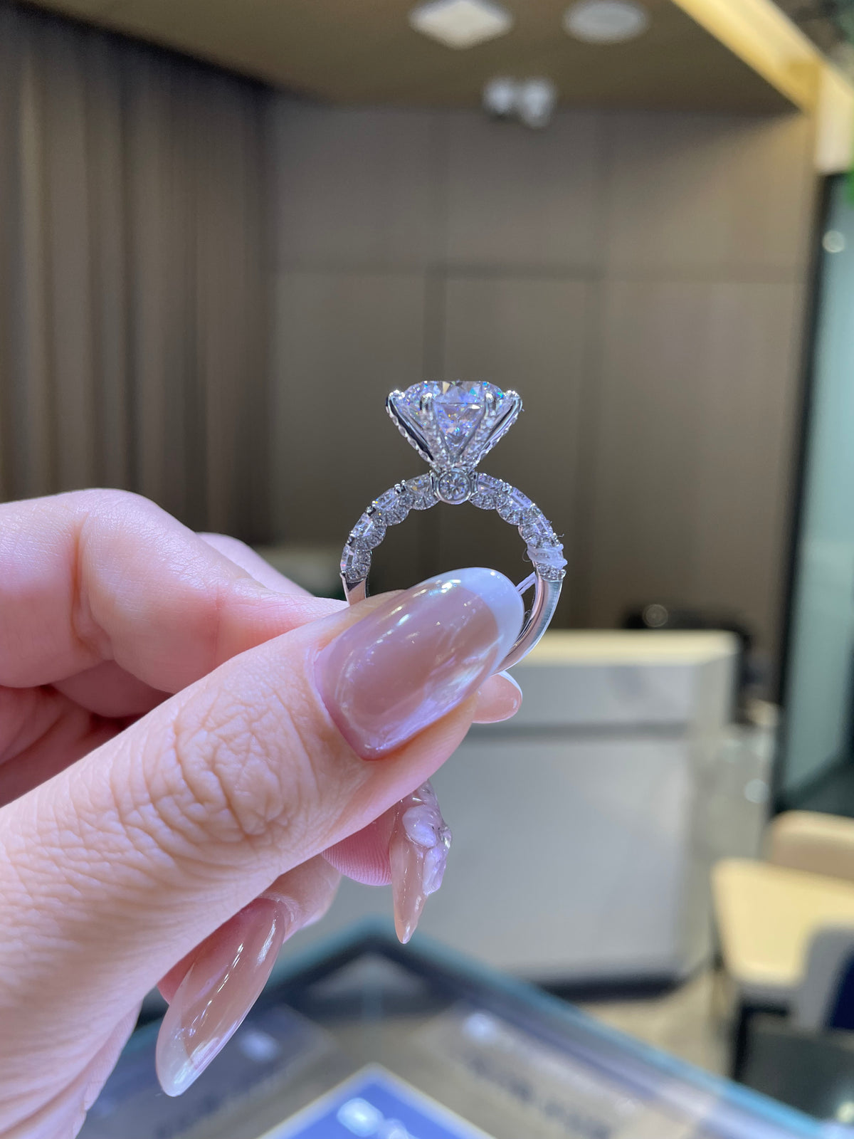 For Couttee, 5.2ct Round with 1.86ct side stones, in platinum