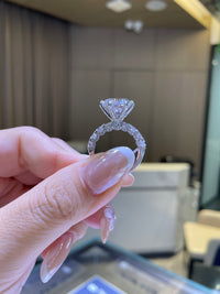 For Couttee, 5.2ct Round with 1.86ct side stones, in platinum