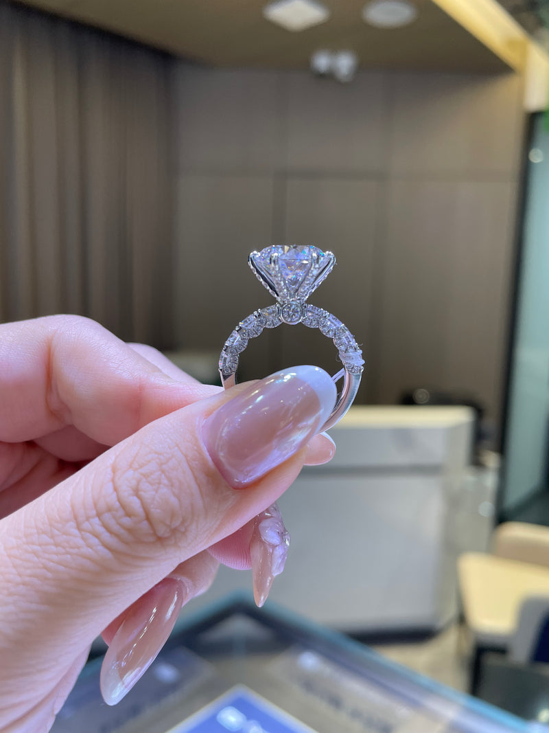 For Couttee, 5.2ct Round with 1.86ct side stones, in platinum