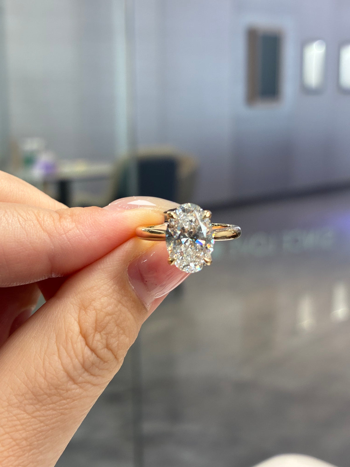For LiLI, 3.05ct Oval solitaire engagement ring with 0.095ct sidestones, D/VVS2 in 14k yellow gold