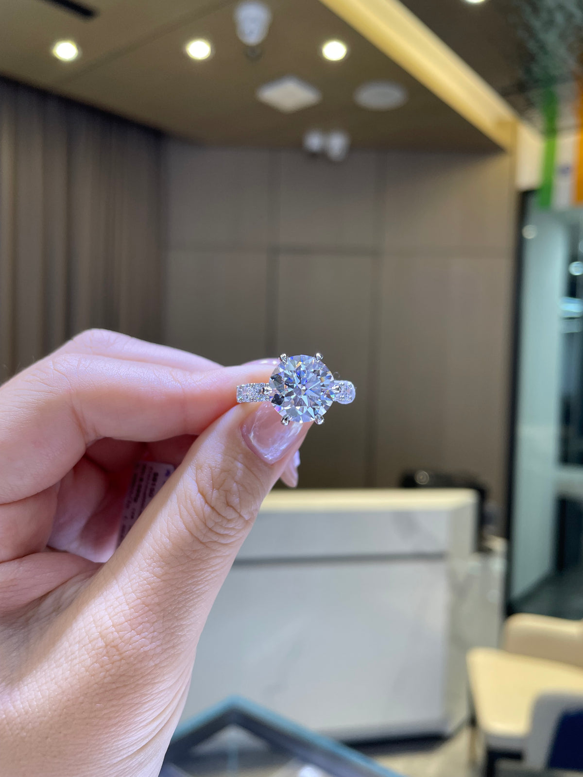 For Couttee, 5.2ct Round with 1.86ct side stones, in platinum
