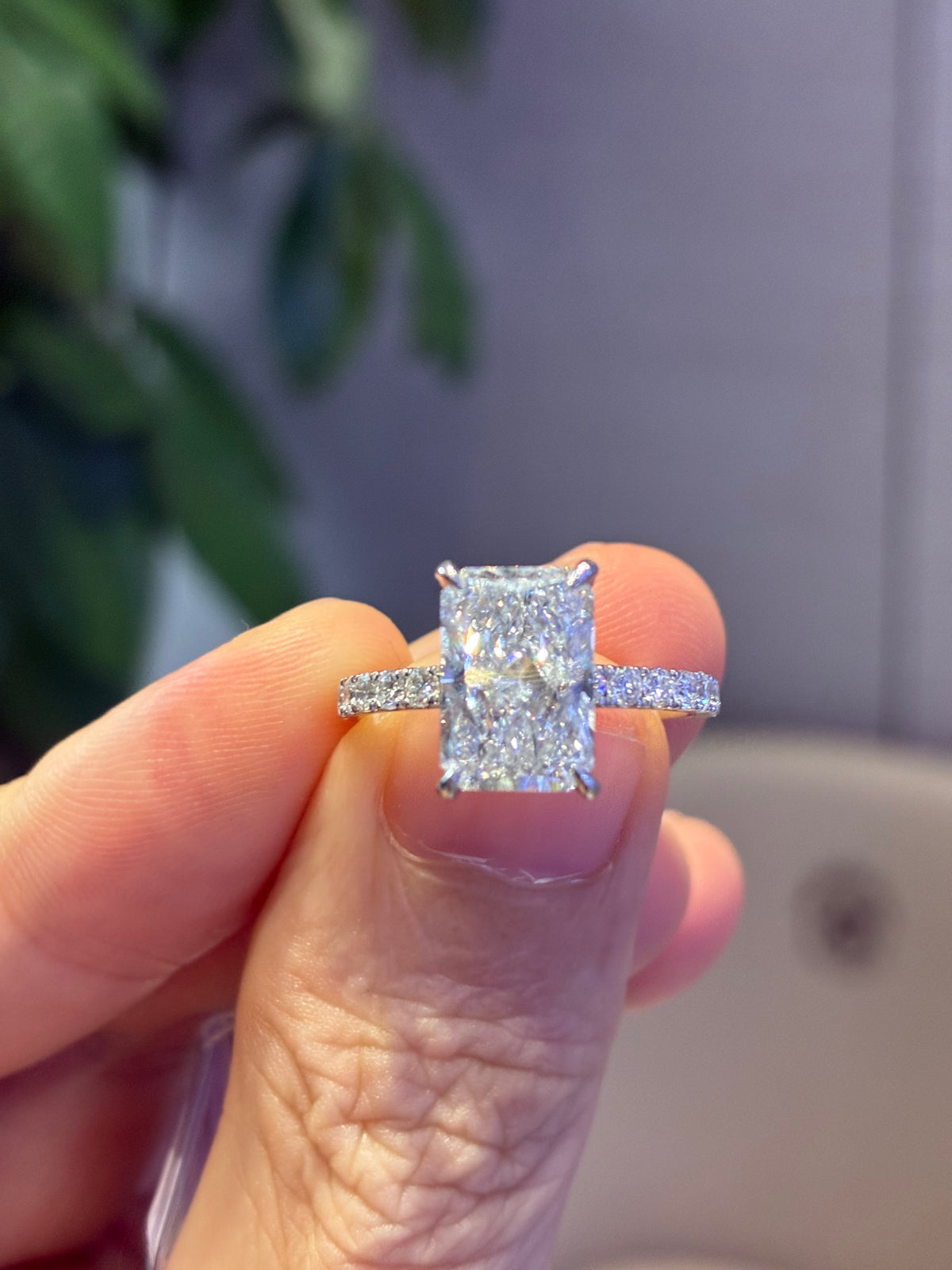 For Risse 3.03 carats E/VS1 radiant with 0.560 carats sidestones in 14k white gold