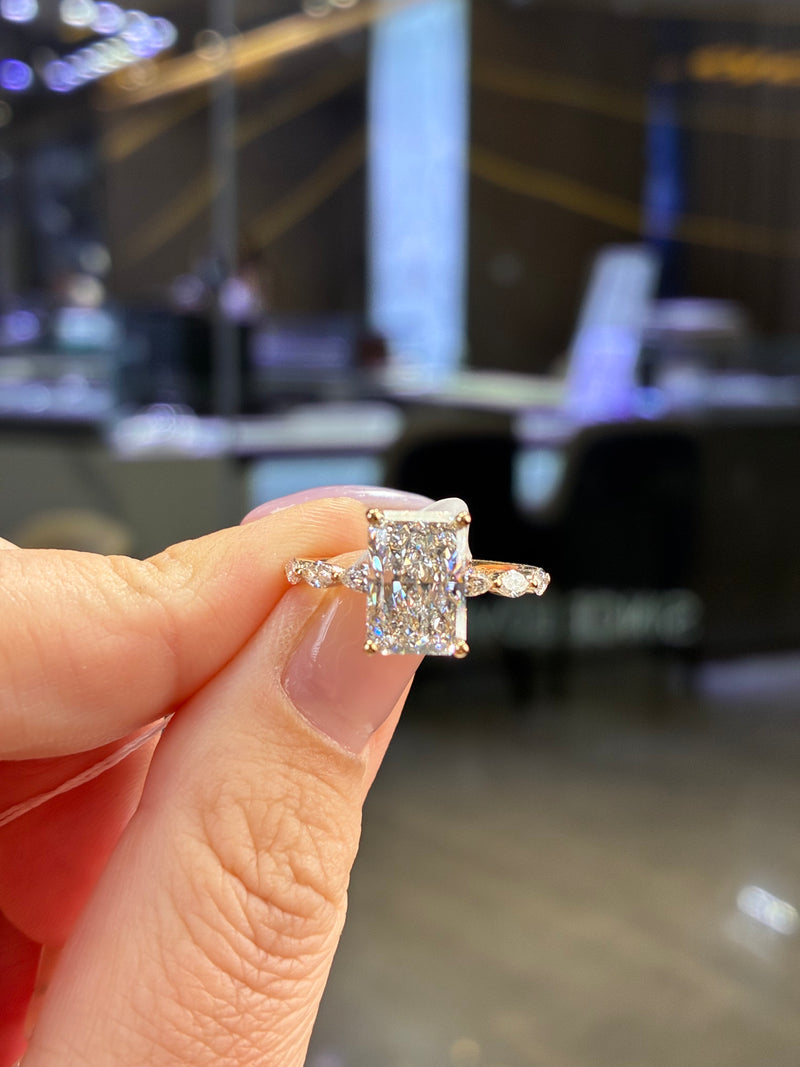 For peach, 2.01ct radiant with 0.48ct side stones. E/VVS2 in 14k yellow gold