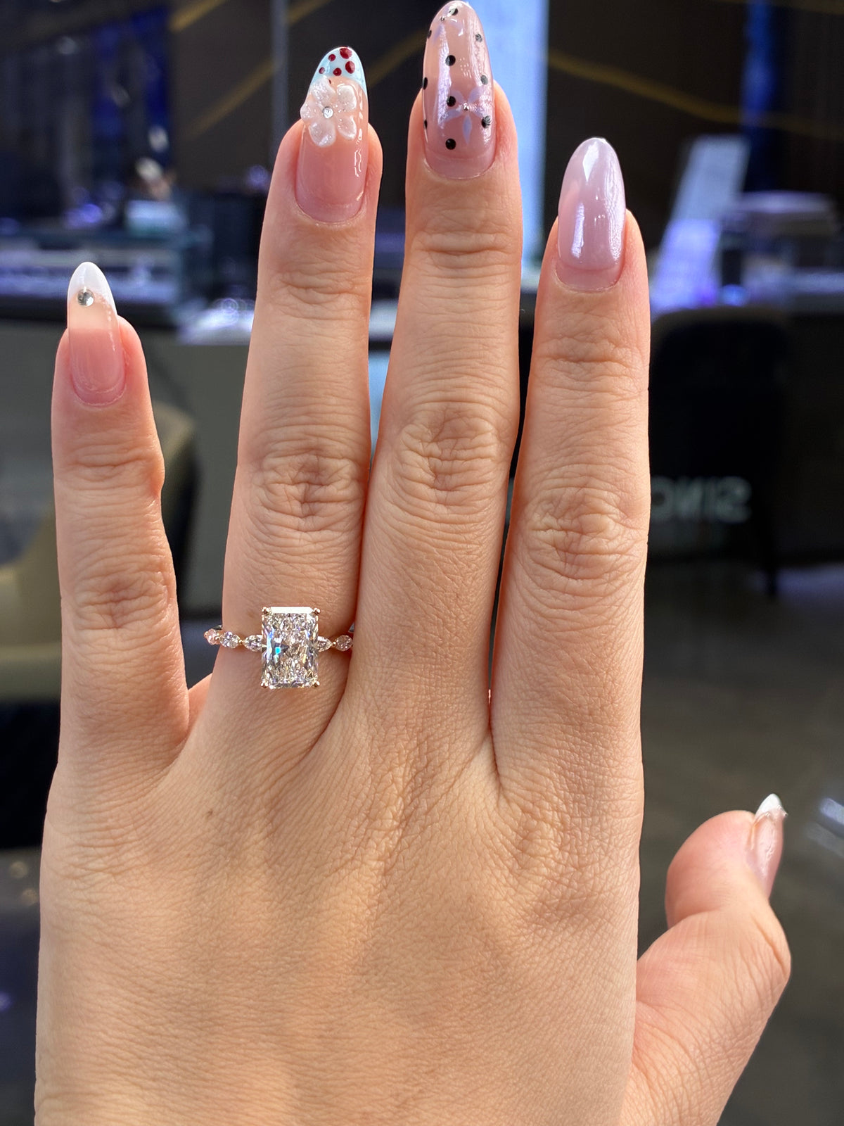 For peach, 2.01ct radiant with 0.48ct side stones. E/VVS2 in 14k yellow gold