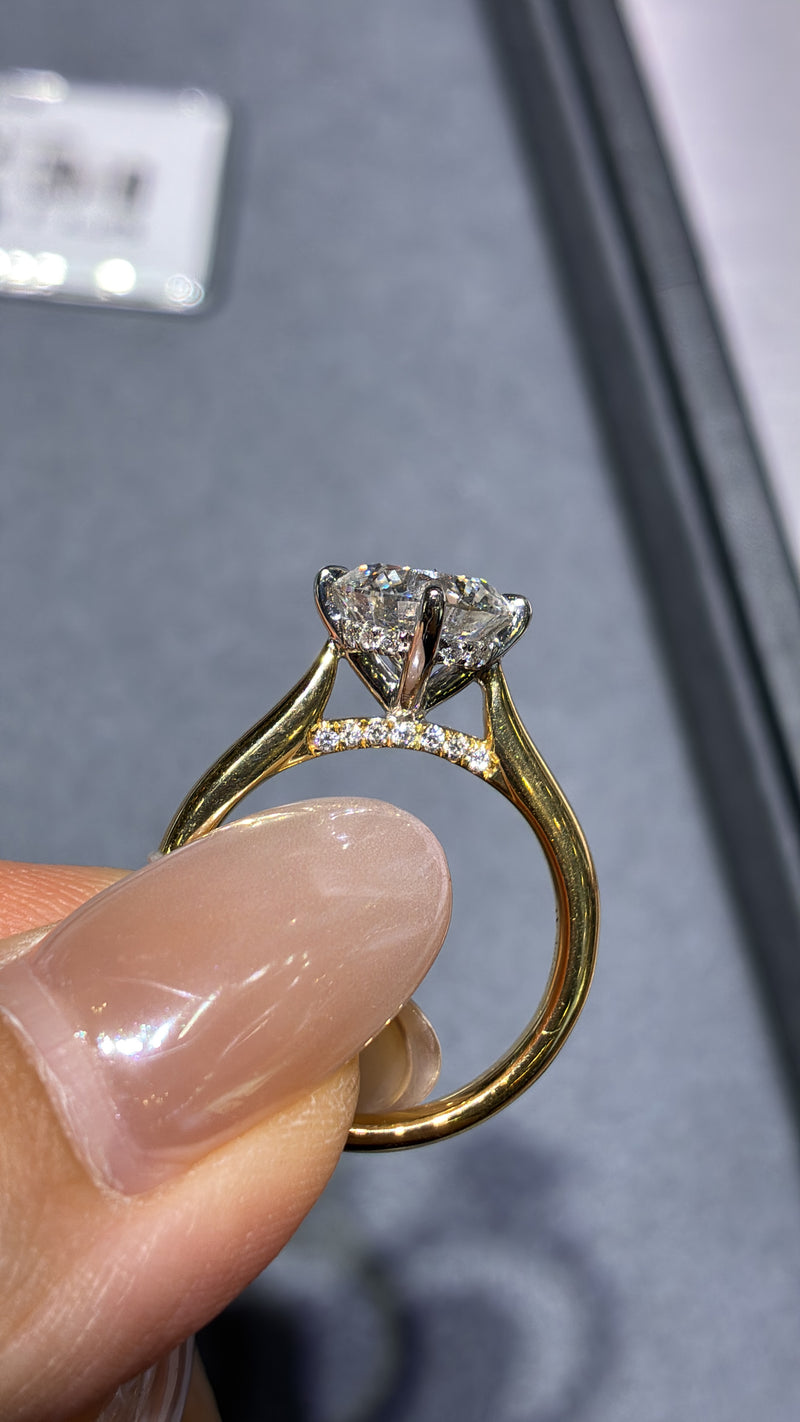 For Natia, custom 14K Gold 1.5ct Round Two tone cathedral setting with diamond on bridge, half pave band, compass prongs, E/VS1