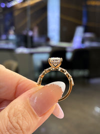 For Legacy, 2.76ct Radiant center stone with 0.49ct sidestones, E/VVS2, in 14K yellow gold