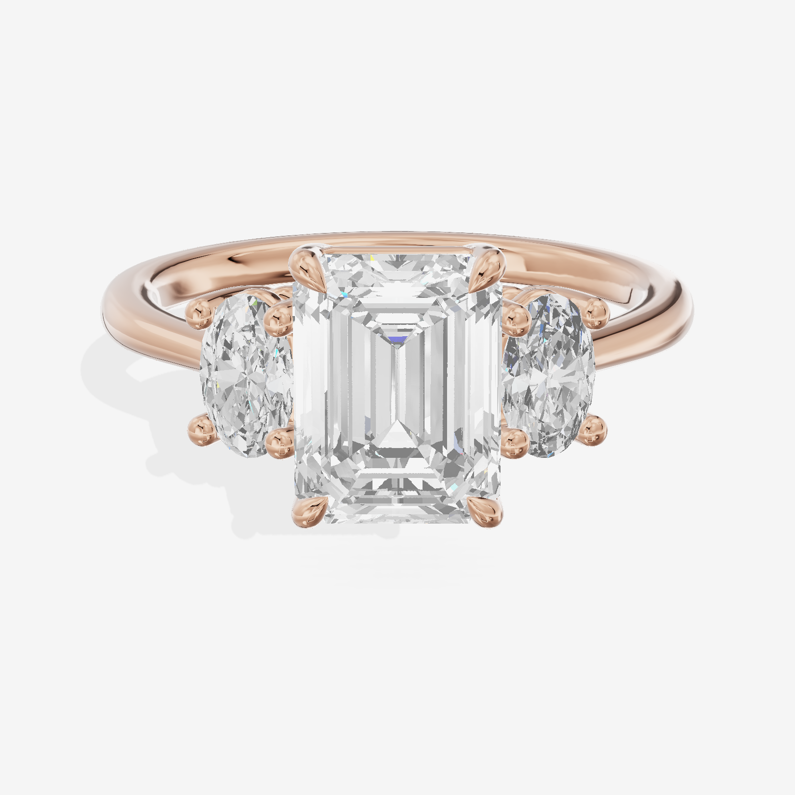 Modern Coeurine Three Stone Emerald Engagement Ring (1/2 ct. tw.) in 18K Rose Gold